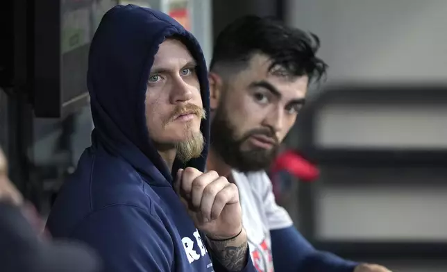 Boston Red Sox pitcher Tanner Houck, left, sits with catcher Connor Wong in the dugout after the third inning of the team's baseball game against the Chicago White Sox on Thursday, June 6, 2024, in Chicago. (AP Photo/Charles Rex Arbogast)