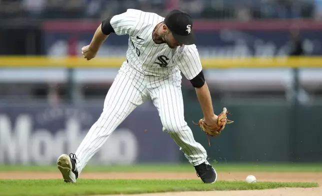 Chicago White Sox shortstop Paul DeJong is unable to handle a single by Boston Red Sox's Dominic Smith during the third inning of a baseball game Thursday, June 6, 2024, in Chicago. (AP Photo/Charles Rex Arbogast)