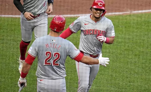 Cincinnati Reds' Santiago Espinal, right, celebrates with Luke Maile (22) as he returns to the dugout after hitting a two-run home run off Pittsburgh Pirates starting pitcher Bailey Falter during the fifth inning of a baseball game in Pittsburgh, Tuesday, June 18, 2024. (AP Photo/Gene J. Puskar)