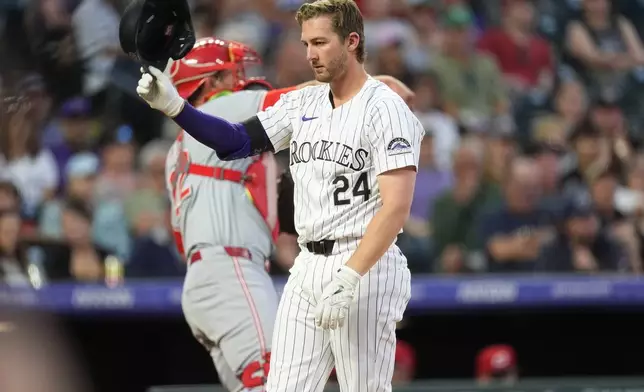 Colorado Rockies' Ryan McMahon tosses his batting helmet after striking out against Cincinnati Reds starting pitcher Frankie Montas to end the sixth inning of a baseball game Tuesday, June 4, 2024, in Denver. (AP Photo/David Zalubowski)