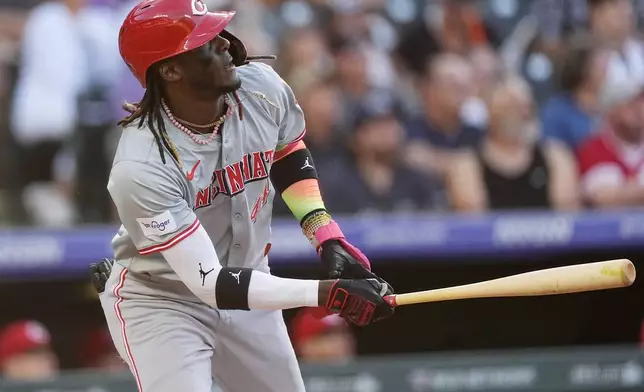 Cincinnati Reds' Elly De La Cruz watches f his solo home run off Colorado Rockies starting pitcher Ty Blach during the third inning of a baseball game Tuesday, June 4, 2024, in Denver. (AP Photo/David Zalubowski)