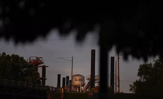 Sloss Furnaces National Historic Landmark is seen through tree brush near downtown Birmingham, Ala, on Tuesday, June 11, 2024. Birmingham will host a regular season MLB baseball game at Rickwood Field. It's known as one of the oldest professional ballpark in the United States and former home of the Birmingham Black Barons of the Negro Leagues. The game between the St. Louis Cardinals and San Francisco Giants is set to be played on June 20, 2024. (AP Photo/Brynn Anderson)