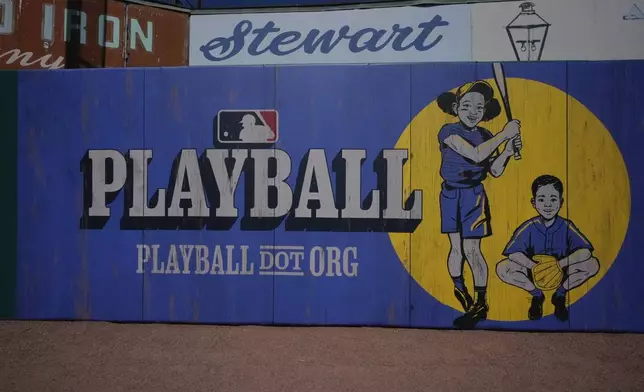 New MLB signs adorn the outfield walls at Rickwood Field, Monday, June 10, 2024, in Birmingham, Ala. Rickwood Field, known as one of the oldest professional ballpark in the United States and former home of the Birmingham Black Barons of the Negro Leagues, will be the site of a special regular season game between the St. Louis Cardinals and San Francisco Giants on June 20, 2024. (AP Photo/Brynn Anderson)