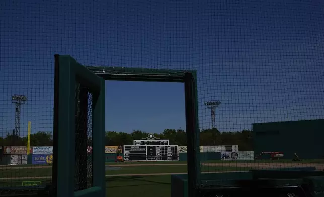 A manual scoreboard is seen through an opening door to the field at Rickwood Field, Monday, June 10, 2024, in Birmingham, Ala. Rickwood Field, known as one of the oldest professional ballpark in the United States and former home of the Birmingham Black Barons of the Negro Leagues, will be the site of a special regular season game between the St. Louis Cardinals and San Francisco Giants on June 20, 2024. (AP Photo/Brynn Anderson)