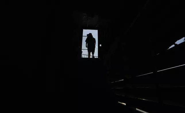 A person walks through an opening near the roof at Rickwood Field, Monday, June 10, 2024, in Birmingham, Ala. Rickwood Field, known as one of the oldest professional ballpark in the United States and former home of the Birmingham Black Barons of the Negro Leagues, will be the site of a special regular season game between the St. Louis Cardinals and San Francisco Giants on June 20, 2024. (AP Photo/Brynn Anderson)