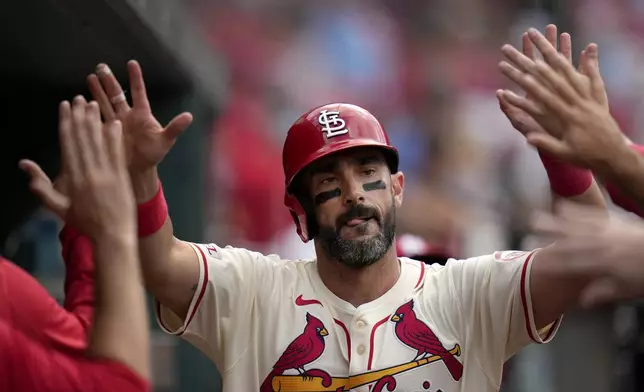 St. Louis Cardinals' Matt Carpenter is congratulated by teammates after hitting a solo home run during the seventh inning of a baseball game against the Colorado Rockies Saturday, June 8, 2024, in St. Louis. (AP Photo/Jeff Roberson)
