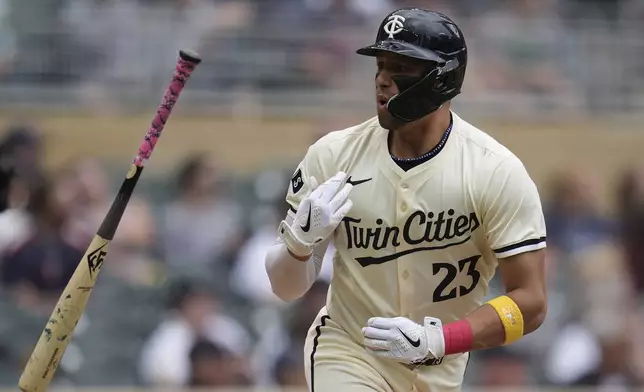 Minnesota Twins' Royce Lewis (23) flips his bat after hitting a two-run home run during the sixth inning of a baseball game against the Colorado Rockies, Wednesday, June 12, 2024, in Minneapolis. (AP Photo/Abbie Parr)