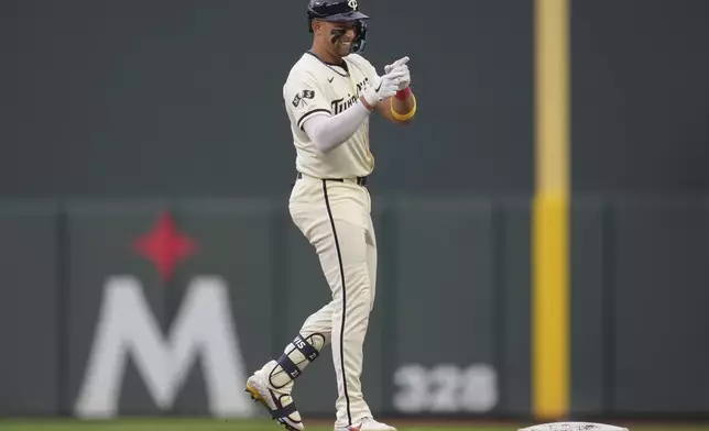Minnesota Twins' Royce Lewis gestures after hitting a single during the first inning of a baseball game against the Colorado Rockies, Wednesday, June 12, 2024, in Minneapolis. (AP Photo/Abbie Parr)