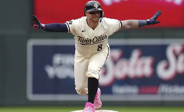 Minnesota Twins' Christian Vázquez (8) celebrates after hitting a two-run double during the eighth inning of a baseball game against the Colorado Rockies, Wednesday, June 12, 2024, in Minneapolis. (AP Photo/Abbie Parr)