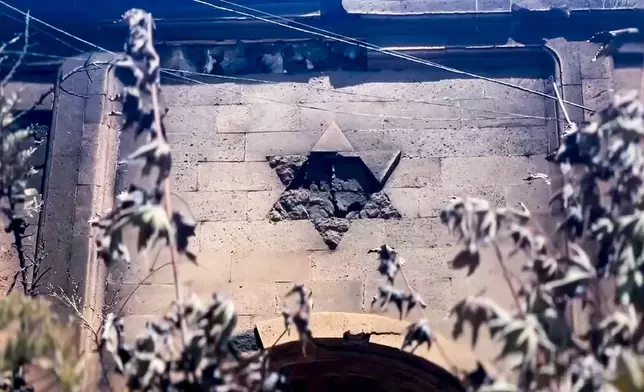 In this photo taken from video released by The Telegram Channel of the head of Dagestan Republic of Russia on Monday, June 24, 2024, A damaged by terrorists David's star is seen on the wall of the the Kele-Numaz synagogue in Derbent after a counter-terrorist operation in republic of Dagestan, Russia. Multiple police officers and several civilians, including an Orthodox priest, were killed by armed militants in Russia's southern republic of Dagestan on Sunday, its governor Sergei Melikov said in a video statement early Monday. (The Telegram Channel of the head of Dagestan Republic of Russia via AP)