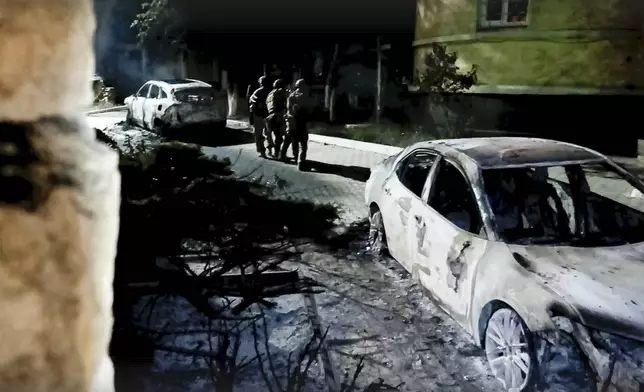 In this photo taken from video released by the National Antiterrorism Committee on Monday, June 24, 2024, FSB officers conduct a counter-terrorist operation in republic of Dagestan, Russia. Multiple police officers and several civilians, including an Orthodox priest, were killed by armed militants in Russia's southern republic of Dagestan on Sunday, its governor Sergei Melikov said in a video statement early Monday. (The National Antiterrorism Committee via AP)