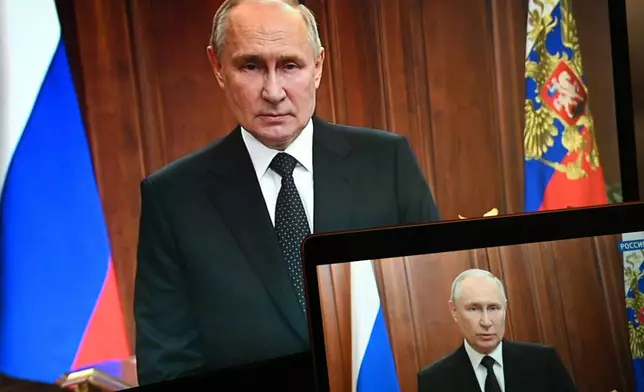 FILE - Russian President Vladimir Putin is seen on monitors in Moscow, Russia, on June 24, 2023, as he addresses the nation after a brief rebellion by mercenary leader Yevgeny Prigozhin. The mercenary group had taken over a military headquarters in the southern city of Rostov-on-Don. Putin denounced the rebellion by his onetime protege as a "betrayal" and "treason." (Pavel Bednyakov, Sputnik, Kremlin Pool Photo via AP, File)