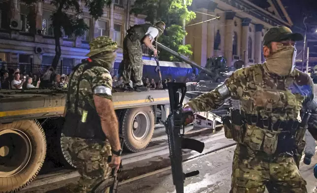 ILE - Mercenaries of Russia's Wagner Group load a tank onto a truck in Rostov-on-Don, Russia, on June 24, 2023, following a brief rebellion led by Wagner chief Yevgeny Prigozhin. He had accused Defense Ministry officials of denying support to his fighters in Ukraine. The troops had taken over Russia's southern military headquarters in Rostov-on-Don and headed for Moscow but aborted the rebellion, which still undermined Putin's image of power. Prigozhin was killed two months later in a mysterious plane crash. (Vasily Deryugin/Kommersant Publishing House via AP, File)