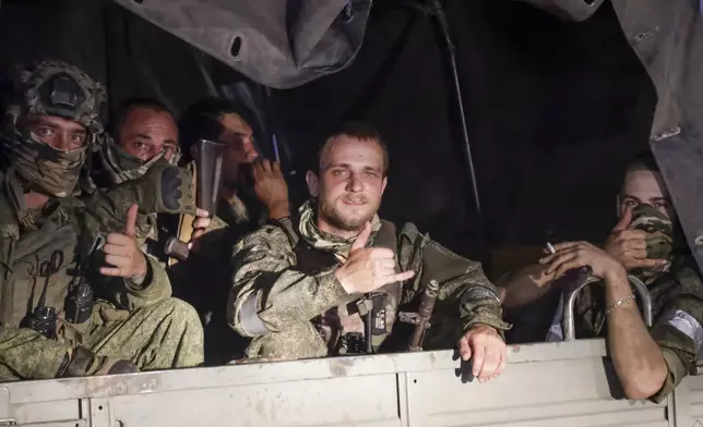 FILE - Members of the Wagner Group private military contractor sit in vehicle in Rostov-on-Don, Russia, on June 24, 2023, as they prepare to leave an area at the headquarters of the Southern Military District. Wagner chief Yevgeny Prigozhin launched a rebellion that sought the ouster of Defense Ministry officials that he accused of not supplying his forces fighting in Ukraine, but he later called it off. (AP Photo, File)