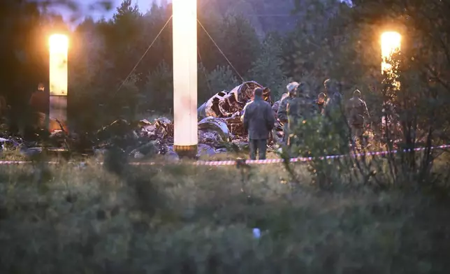 FILE - Lights Illuminate debris of a private jet that crashed near the village of Kuzhenkino, Russia, on Aug. 24, 2023. The jet, flying from Moscow to St. Petersburg, was carrying Wagner Group head Yevgeny Prigozhin, who two months earlier launched a brief armed rebellion. Prigozhin and nine others aboard the jet were killed. (AP Photo, File)