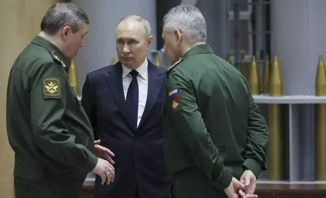 FILE - Russian President Vladimir Putin, center, talks with Gen. Valery Gerasimov, left, chief of the General Staff, and Defense Minister Sergei Shoigu after a meeting in Moscow, Russia, on Dec. 19, 2023. An armed uprising by mercenary chief Yevgeny Prigozhin on June 23-24, 2023, against the military leadership dealt a blow to Putin’s authority. (Mikhail Klimentyev, Sputnik, Kremlin Pool Photo via AP, File)