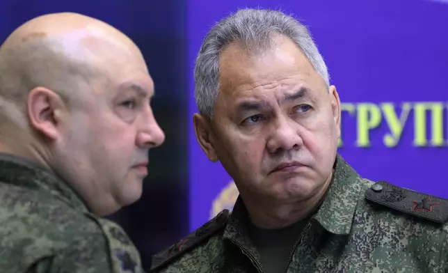 FILE - The top Russian military commander in Ukraine, Gen. Sergei Surovikin, left, and Russian Defense Minister Sergei Shoigu attend a meeting at an unknown location on Dec. 17, 2022, with President Vladimir Putin during his visit to troops fighting in Ukraine. Surovikin, who reportedly had close ties with Russian mercenary chief Yevgeny Prigozhin, was stripped of his post as deputy commander of forces in Ukraine after the brief uprising by Prigozhin on June 23-24, 2023. (Gavriil Grigorov, Sputnik, Kremlin Pool Photo via AP, File)