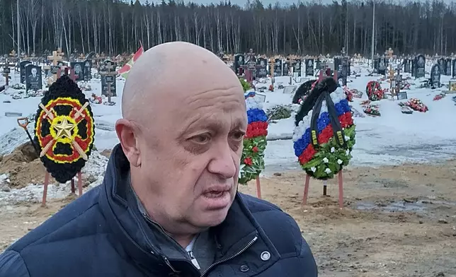 FILE - Wagner Group head Yevgeny Prigozhin attends the funeral at the Beloostrovskoye Cemetery outside St. Petersburg, Russia, on Dec. 24, 2022, of Dmitry Menshikov, one of his mercenaries who died fighting in Ukraine. Prigozhin made his name as the profane and brutal mercenary boss who in June 2023 mounted a brief armed rebellion that was the most serious challenge to the rule of Russian President Vladimir Putin. (AP Photo, File)