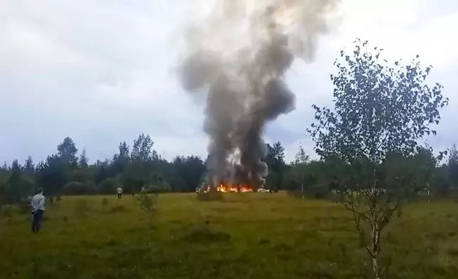 FILE - In this image taken from video, smoke rises from the crash of a private jet near the village of Kuzhenkino, Russia, on Aug. 23, 2023. The jet, flying from Moscow to St. Petersburg, was carrying Wagner Group head Yevgeny Prigozhin, who two months earlier launched a brief armed rebellion. Prigozhin and nine others aboard the jet were killed. (AP Photo, File)