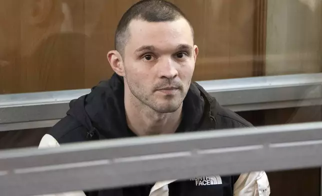 FILE - U.S. Army Staff Sgt. Gordon Black sits in a defendants’ cage in courtroom in Vladivostok, Russia,on June 6, 2024. The 34-year-old, who is stationed at Fort Cavazos, Texas, was convicted June 19 of stealing and making threats against his girlfriend and sentenced to three years and nine months in prison. He had flown to Russia from his U.S. military post in South Korea to see her and was arrested in May after she accused him of stealing from her, according to U.S. and Russian authorities. (AP Photo, File)