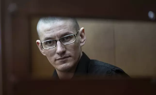 FILE - U.S. citizen Robert Woodland Romanov sits in a defendants’ cage before a court session on drug-related charges in Moscow, Russia, on May 30, 2024. Russian media reported his name matches that of a U.S. citizen interviewed by the Komsomolskaya Pravda newspaper in 2020 in which he said he was born in the Perm region in the Ural Mountains in 1991 and adopted by an American couple when he was 2. (AP Photo/Alexander Zemlianichenko, File)