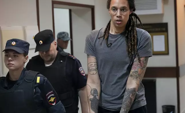 FILE - WNBA star Brittney Griner is escorted from court after a hearing in Khimki, just outside Moscow, Russia, on Aug. 4, 2022. The U.S. successfully negotiated a swap for Griner and Marine veteran Trevor Reed — both designated as wrongfully detained. Moscow got arms dealer Viktor Bout, who was serving a 25-year sentence, and pilot Konstantin Yaroshenko, serving 20 years for cocaine trafficking. (AP Photo/Alexander Zemlianichenko, File)