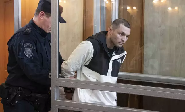 FILE - U.S. Army Staff Sgt. Gordon Black is escorted into a courtroom in Vladivostok, Russia, Thursday, June 6, 2024. The 34-year-old, who is stationed at Fort Cavazos, Texas, was convicted June 19 of stealing and making threats against his girlfriend and sentenced to three years and nine months in prison. He had flown to Russia from his U.S. military post in South Korea her and was arrested in May after she accused him of stealing from her, according to U.S. and Russian officials. (AP Photo, File)