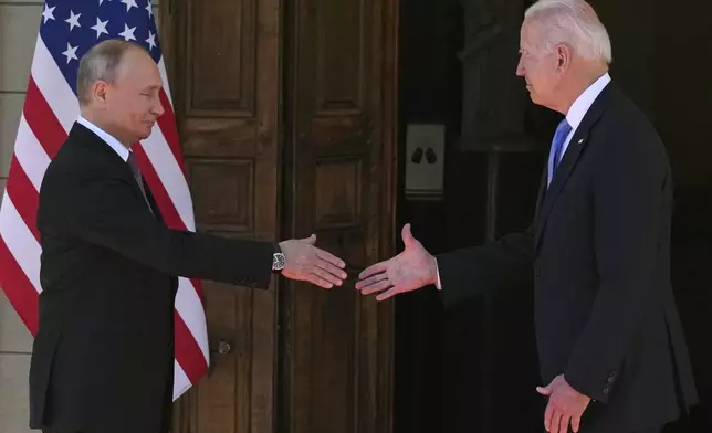 FILE - Russian President Vladimir Putin, left, and U.S President Joe Biden shake hands at a meeting in Geneva, Switzerland, on June 16, 2021. Arrests of Americans in Russia have become increasingly common as relations between Moscow and Washington sink to Cold War lows. Some have been exchanged for Russians held in the U.S., while for others, the prospects of being released in a swap are less clear. (AP Photo/Alexander Zemlianichenko, Pool, File)