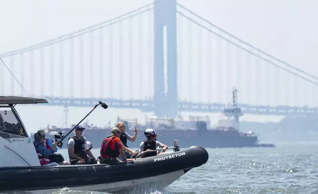 Lindsey Vonn, second from right, Olympic skiing champion, rides a USA SailGP Team chase boat during racing practice ahead of the New York Sail Grand Prix, Friday, June 21, 2024, in New York. (AP Photo/Julia Nikhinson)