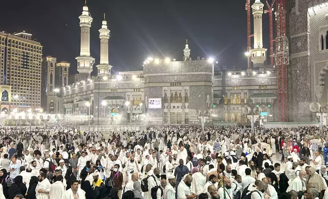 Pilgrims leave after offering prayers outside at the Grand Mosque during the annual Hajj pilgrimage in Mecca, Saudi Arabia, early Friday, June 14, 2024. Hajj is the annual Islamic pilgrimage to Mecca in Saudi Arabia that is required once in a lifetime of every Muslim who can afford it and is physically able to make it. Some Muslims make the journey more than once. (AP Photo/Rafiq Maqbool)