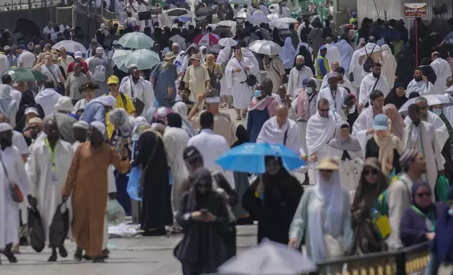Pilgrims leave after offering prayers outside at the Grand Mosque, during the annual Hajj pilgrimage in Mecca, Saudi Arabia, Thursday, June 13, 2024. Hajj is the annual Islamic pilgrimage to Mecca in Saudi Arabia that is required once in a lifetime of every Muslim who can afford it and is physically able to make it. Some Muslims make the journey more than once. (AP Photo/Rafiq Maqbool)