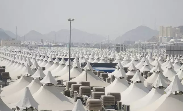 Tents for Muslim pilgrims fill the Mina tent camp as Muslim pilgrims arrive during the annual Hajj pilgrimage, near the holy city of Mecca, Saudi Arabia, Friday, June 14, 2024. Hajj is the annual Islamic pilgrimage to Mecca in Saudi Arabia that is required once in a lifetime of every Muslim who can afford it and is physically able to make it. Some Muslims make the journey more than once. (AP Photo/Rafiq Maqbool)