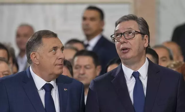 Bosnian Serb political leader Milorad Dodik, left, speaks with Serbian President Aleksandar Vucic during the prayer service for the All-Serbian Assembly in the St. Sava Serbian Orthodox temple in Belgrade, Serbia, Saturday, June 8, 2024. The All-Serbian Assembly carries the main message that Serbs, wherever they live, are one people, that they strive for the same goals. (AP Photo/Darko Vojinovic)