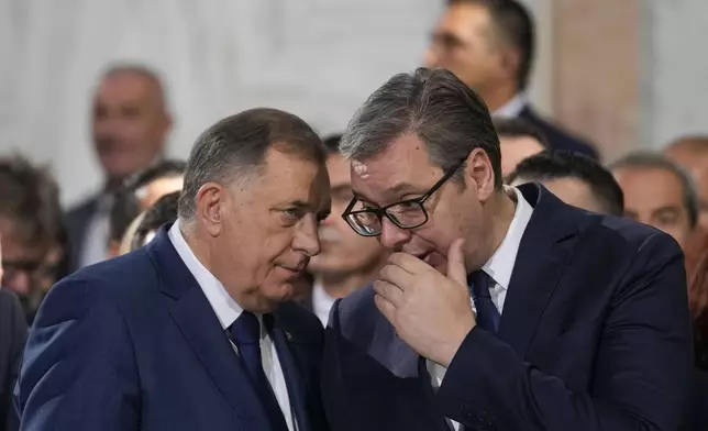 Bosnian Serb political leader Milorad Dodik, left, speaks with Serbian President Aleksandar Vucic during the prayer service for the All-Serbian Assembly in the St. Sava Serbian Orthodox temple in Belgrade, Serbia, Saturday, June 8, 2024. The All-Serbian Assembly carries the main message that Serbs, wherever they live, are one people, that they strive for the same goals. (AP Photo/Darko Vojinovic)