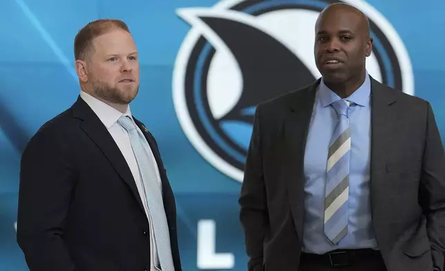 Ryan Warsofsky, left, talks with San Jose Sharks general manager Mike Grier before a news conference introducing Warsofsky as the NHL hockey head coach of the Sharks in San Jose, Calif., Monday, June 17, 2024. (AP Photo/Jeff Chiu)