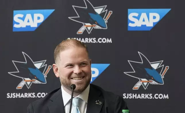 Ryan Warsofsky speaks at a news conference where he was introduced as the NHL hockey head coach of the San Jose Sharks in San Jose, Calif., Monday, June 17, 2024. (AP Photo/Jeff Chiu)