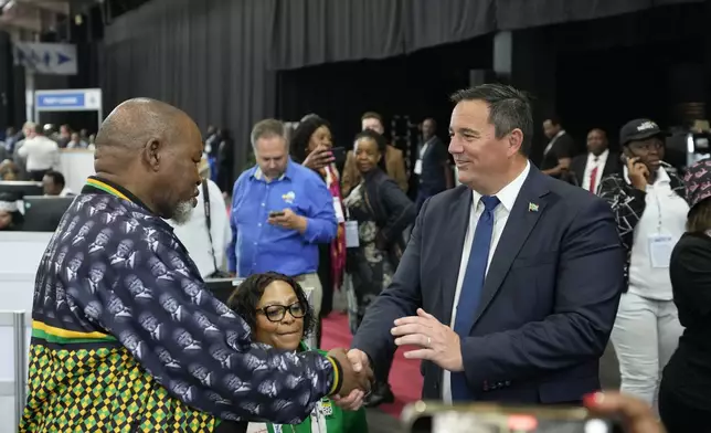 FILE - Leader of the main opposition Democratic Alliance John Steenhuisen, right, shakes hands with ANC's Chairman Gwede Mantashe, left, after elections on a visit to the Results Operation Centre (ROC) in Midrand, Johannesburg, South Africa, on May 31, 2024. (AP Photo/Themba Hadebe, File)