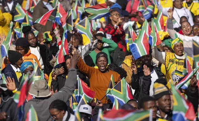 FILE - South Africans gather ahead of the inauguration of South Africa's Cyril Ramaphosa as President at the Union Buildings South Lawns in Pretoria, South Africa, on June 19, 2024. In a country where racial segregation was once brutally enforced, South Africa's new coalition government has brought a Black president and a white opposition leader together in what is on the face of it a picture of unity. (AP Photo/Jerome Delay, File)