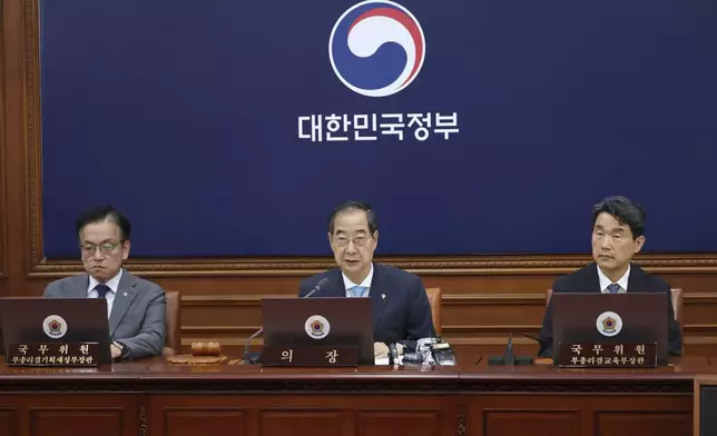 South Korea's Prime Minster Han Duck-soo, center, speaks during a cabinet meeting at the government complex in Seoul, South Korea, Tuesday, June 4, 2024. South Korea’s government has approved the suspension of a contentious military agreement with North Korea, a step that would allow it to take tougher responses to North Korean provocations. (Choi Jae-gu/Yonhap via AP)