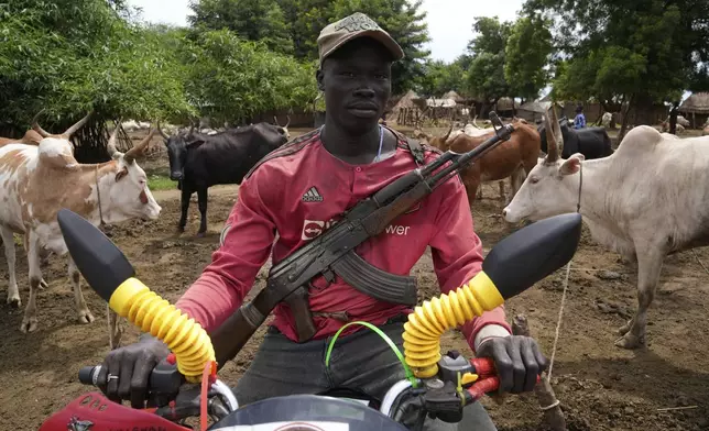 Charo Ochogi poses for a photo in Otallo village, South Sudan, Wednesday, June 19, 2024. Ochogi said he's not worried about the animals disappearing. (AP Photo/Brian Inganga)