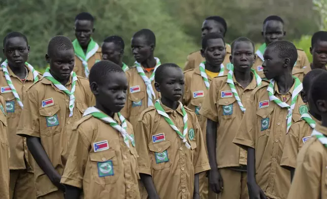 Local Scouts, who are taught about the importance of protecting the environment and building skills, gather in Lafon village, South Sudan Tuesday, June 18, 2024. African Parks is trying to square modernizing the country with preserving the wildlife. (AP Photo/Brian Inganga)
