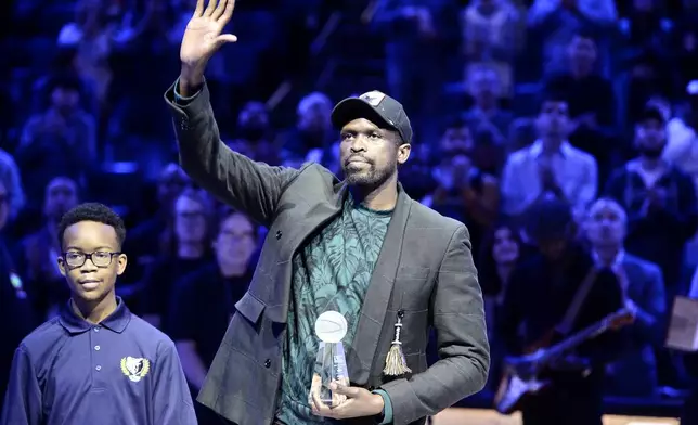 FILE - Luol Deng, right, accepts the 18th annual National Civil Rights Museum Sports Legacy Award before the 21st annual Martin Luther King Jr. Day Celebration Game between the Phoenix Suns and the Memphis Grizzlies, Jan. 16, 2023, in Memphis, Tenn. It’s been only 13 years since South Sudan emerged from its second civil war to become an independent nation. For former NBA star Deng that journey has an almost parallel connection to his own introduction to basketball through fellow Sudanese countryman and former NBA player Manute Bol. (AP Photo/Brandon Dill, File)