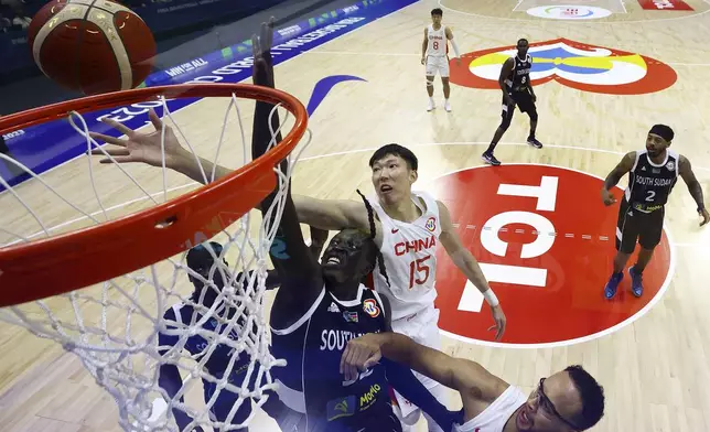 FILE - Wenyen Gabriel (32) of South Sudan competes for a rebound against Zhou Qi (15) and Kyle Anderson (1) of China in the first quarter during the FIBA Basketball World Cup Group B game Aug. 28, 2023, in Manila, Philippines. Luol Deng and South Sudan's coaches tapped into a stable of players with ties to the country who were playing around the world, including former NBA G-League MVP Carlik Jones and others with NBA experience like Gabriel, Nuni Omot and Blair alum Marial Shayok. (Yong Teck Lim/Pool via AP, File)