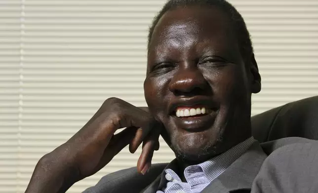 FILE - Former NBA basketball player Manute Bol poses for a photograph at the Sunrise Sudan headquarters in Lenexa, Kan., June 9, 2008. Just 13 years after South Sudan emerged from civil war to become an independent nation in 2011, it will mark a milestone next month when the world’s youngest nation makes its Olympic basketball debut. Bol died in 2010. (AP Photo/Ed Zurga, File)