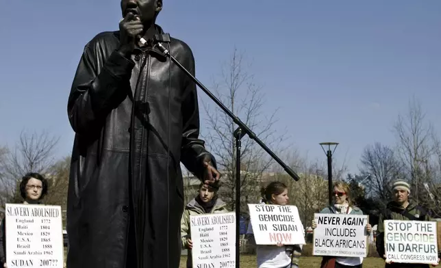 FILE - Former NBA star Manute Bol speaks at a rally March 23, 2006, at the Independence Visitor Center as part of the Philadelphia stop of the Sudan Freedom Walk, a 300-mile march from New York to Washington. Born in Wau, Sudan, Luol Deng was 3 years old when his father Aldo moved with his family to Egypt in the throes of the second Sudanese civil war. It was in Egypt that Deng’s family met Bol, who introduced basketball to Deng and his brothers. (AP Photo/Matt Rourke, File)