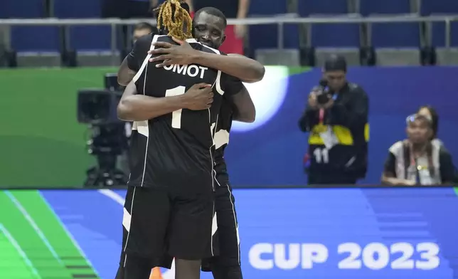 FILE - South Sudan players Nuni Omot (1) and Kuany Ngor Kuany (8) celebrate the team's win against China during a Basketball World Cup group B match at the Araneta Coliseum in Manila, Philippines, Aug. 28, 2023. Luol Deng used millions of his own dollars to fund the team in the first two years. The team's leaders tapped into a stable of players with ties to the country who were playing around the world, including former NBA G-League MVP Carlik Jones and others with NBA experience like Wenyen Gabriel, Omot and Blair alum Marial Shayok. (AP Photo/Aaron Favila, File)