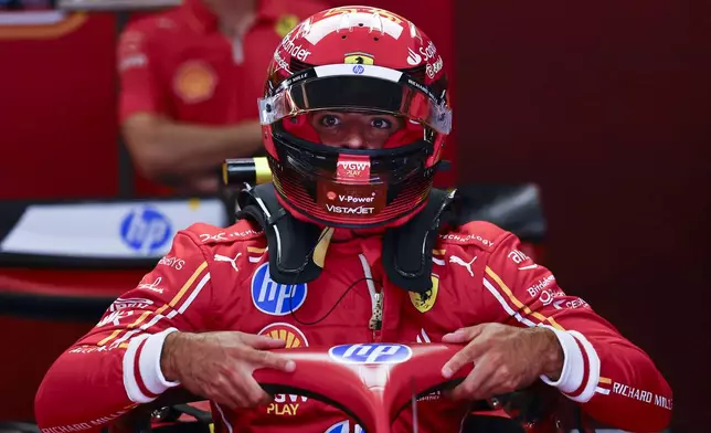 Ferrari driver Carlos Sainz of Spain prepares for the 3rd practice session for the Formula 1 Spanish Grand Prix at the Barcelona Catalunya racetrack in Montmelo, near Barcelona, Spain, Saturday, June 22, 2024. The race will be held on Sunday. (AP Photo/Joan Monfort)