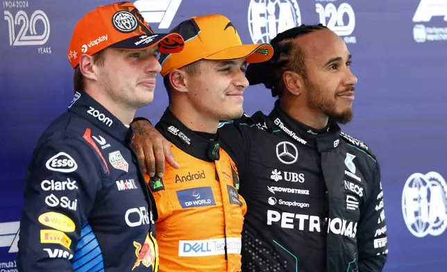 McLaren driver Lando Norris of Britain, center, celebrates after winning the pole position, next to Red Bull driver Max Verstappen of the Netherlands, left, and Mercedes driver Lewis Hamilton of Britain, right, ahead of the Formula 1 Spanish Grand Prix at the Barcelona Catalunya racetrack in Montmelo, near Barcelona, Spain, Saturday, June 22, 2024. The race will be held on Sunday. (AP Photo/Joan Monfort)