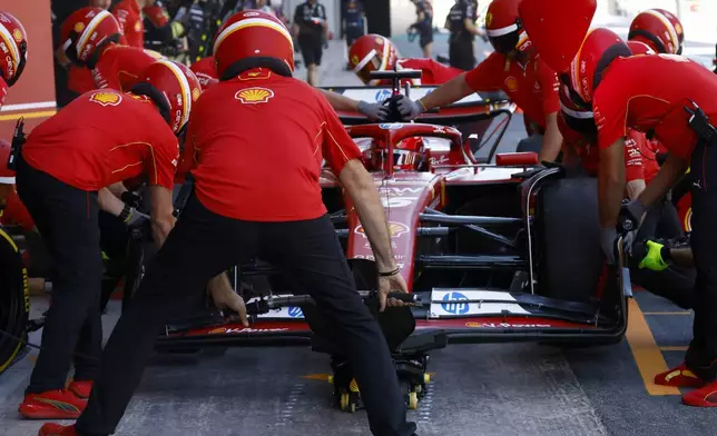 Ferrari driver Charles Leclerc of Monaco arrives at his box during the 2nd practice session for the Formula 1 Spanish Grand Prix at the Barcelona Catalunya racetrack in Montmelo, near Barcelona, Spain, Friday, June 21, 2024. The race will be held on Sunday. (AP Photo/Joan Monfort)