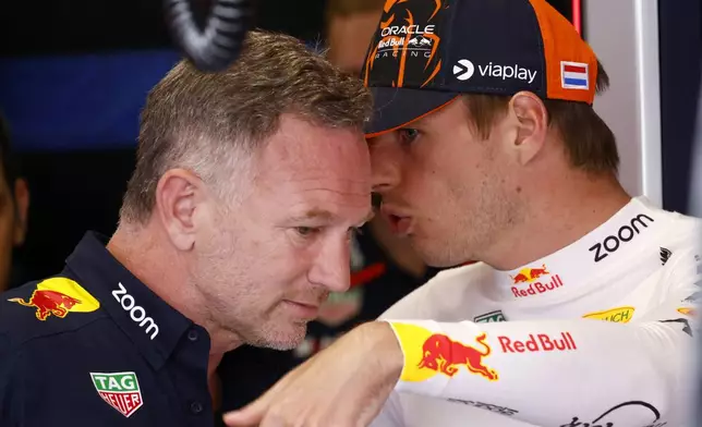 Red Bull Racing CEO, Christian Horner, speaks with Red Bull driver Max Verstappen of the Netherlands, during the 2nd practice session for the Formula 1 Spanish Grand Prix at the Barcelona Catalunya racetrack in Montmelo, near Barcelona, Spain, Friday, June 21, 2024. The race will be held on Sunday. (AP Photo/Joan Monfort)